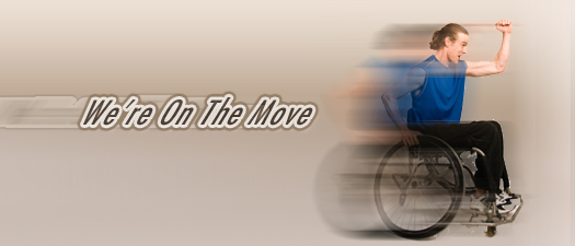 A motion blurred young man in a wheelchair moving forward. Trailing behind him are the words we\'re on the move.